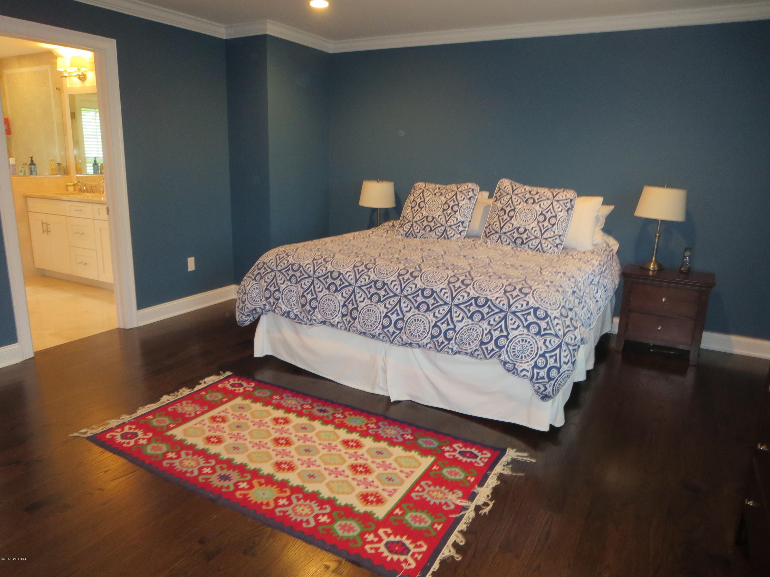 551 River Road Cos Cob, CT 06870 - Photo 18 of 40 a bedroom with a bed and wooden floor