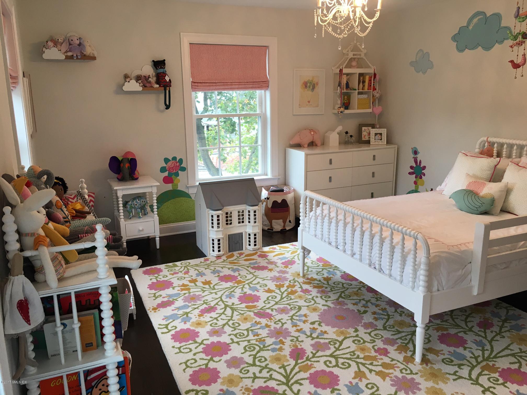 551 River Road Cos Cob, CT 06870 - Photo 19 of 40 a bedroom with a bed and a table in it