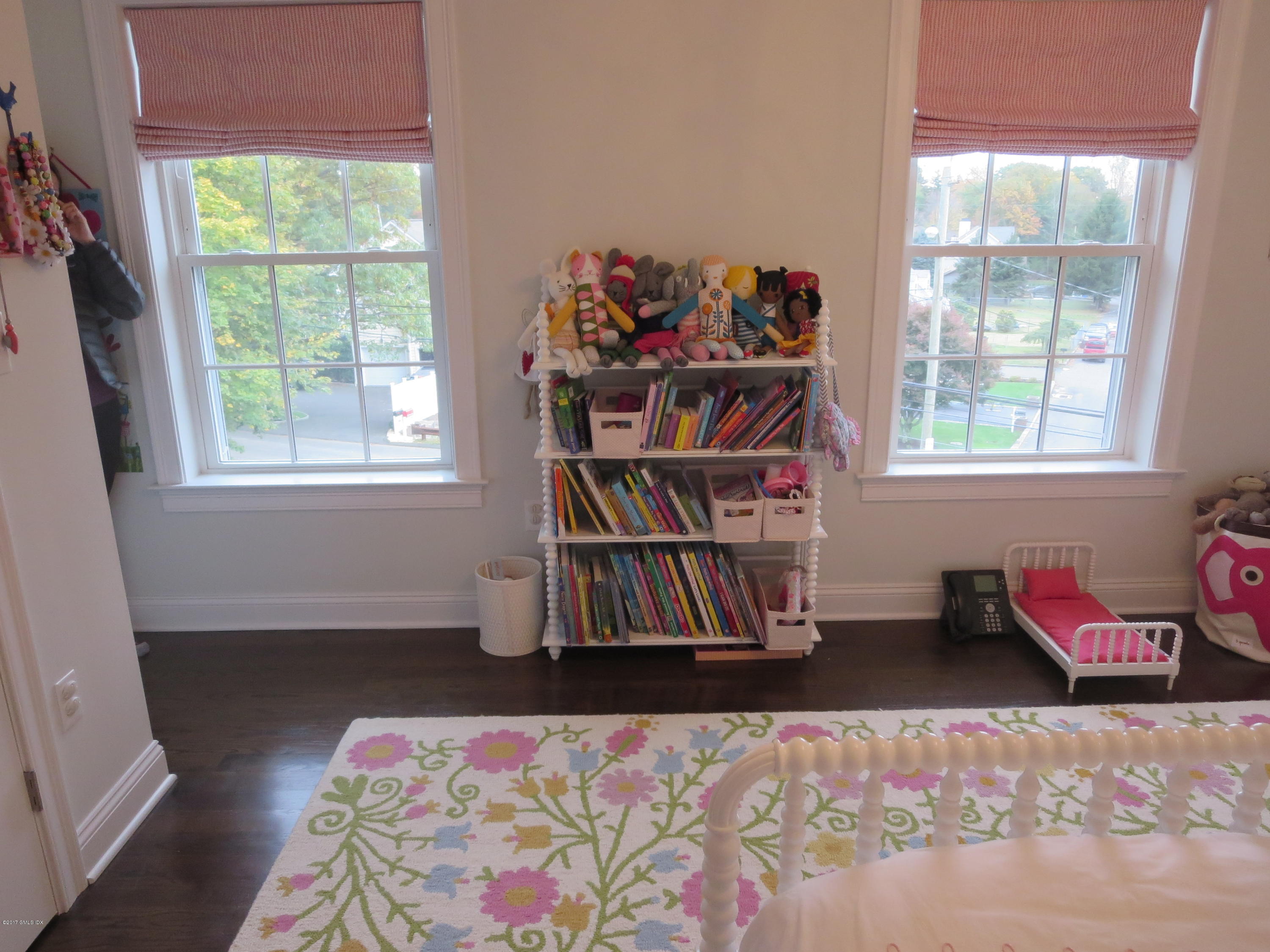 551 River Road Cos Cob, CT 06870 - Photo 21 of 40 a bedroom with furniture and a book shelf