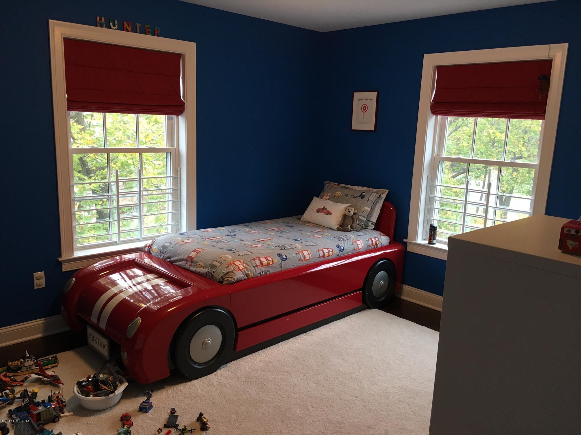 551 River Road Cos Cob, CT 06870 - Photo 22 of 40 a bed sitting in a bedroom next to a window
