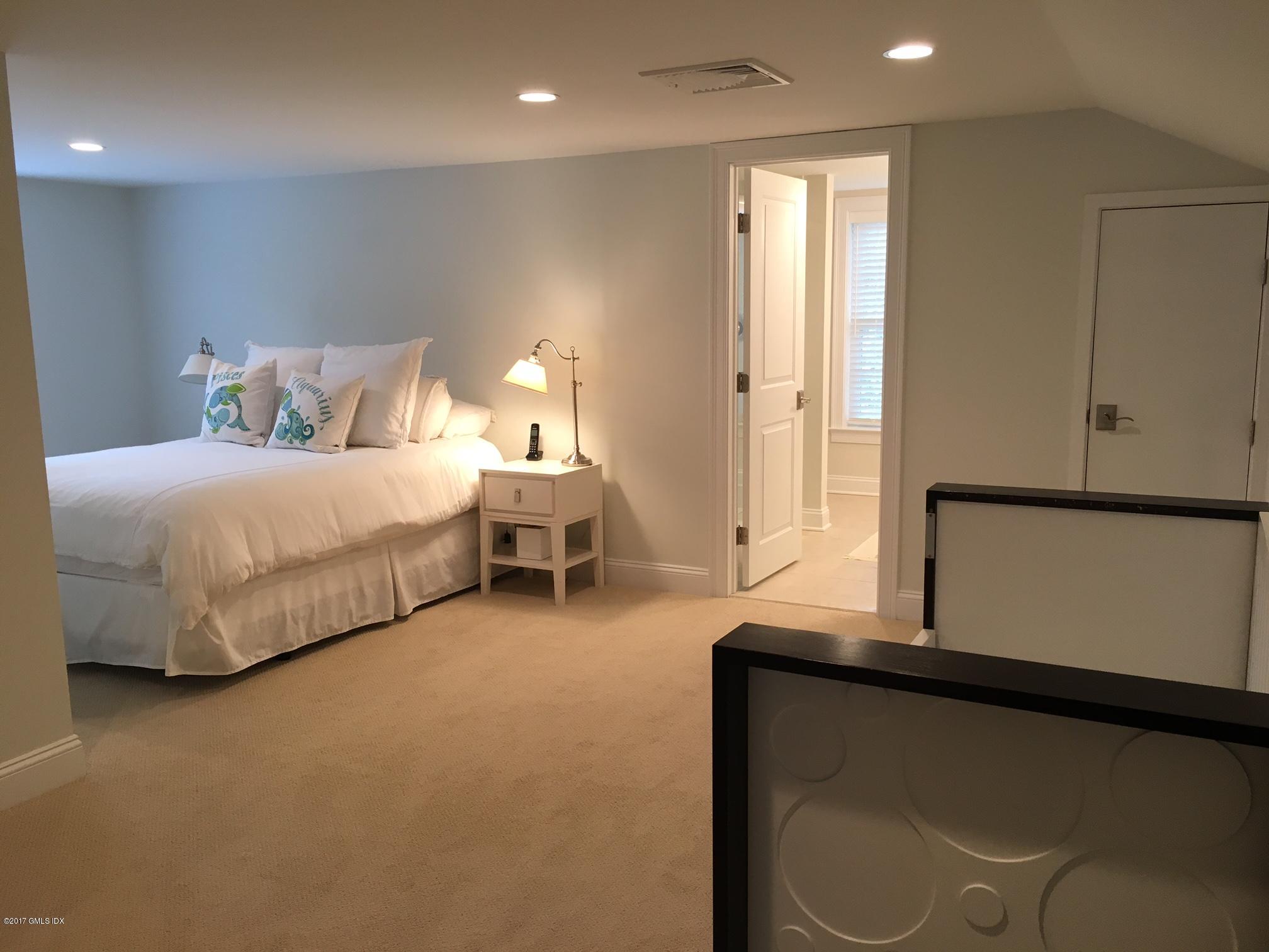 551 River Road Cos Cob, CT 06870 - Photo 26 of 40 a spacious bedroom with a bed and window