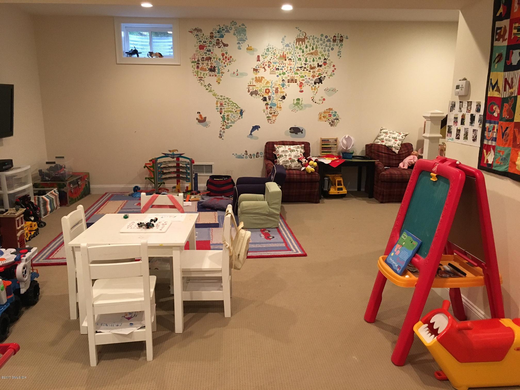 551 River Road Cos Cob, CT 06870 - Photo 31 of 40 a bed room with a bed and a chair