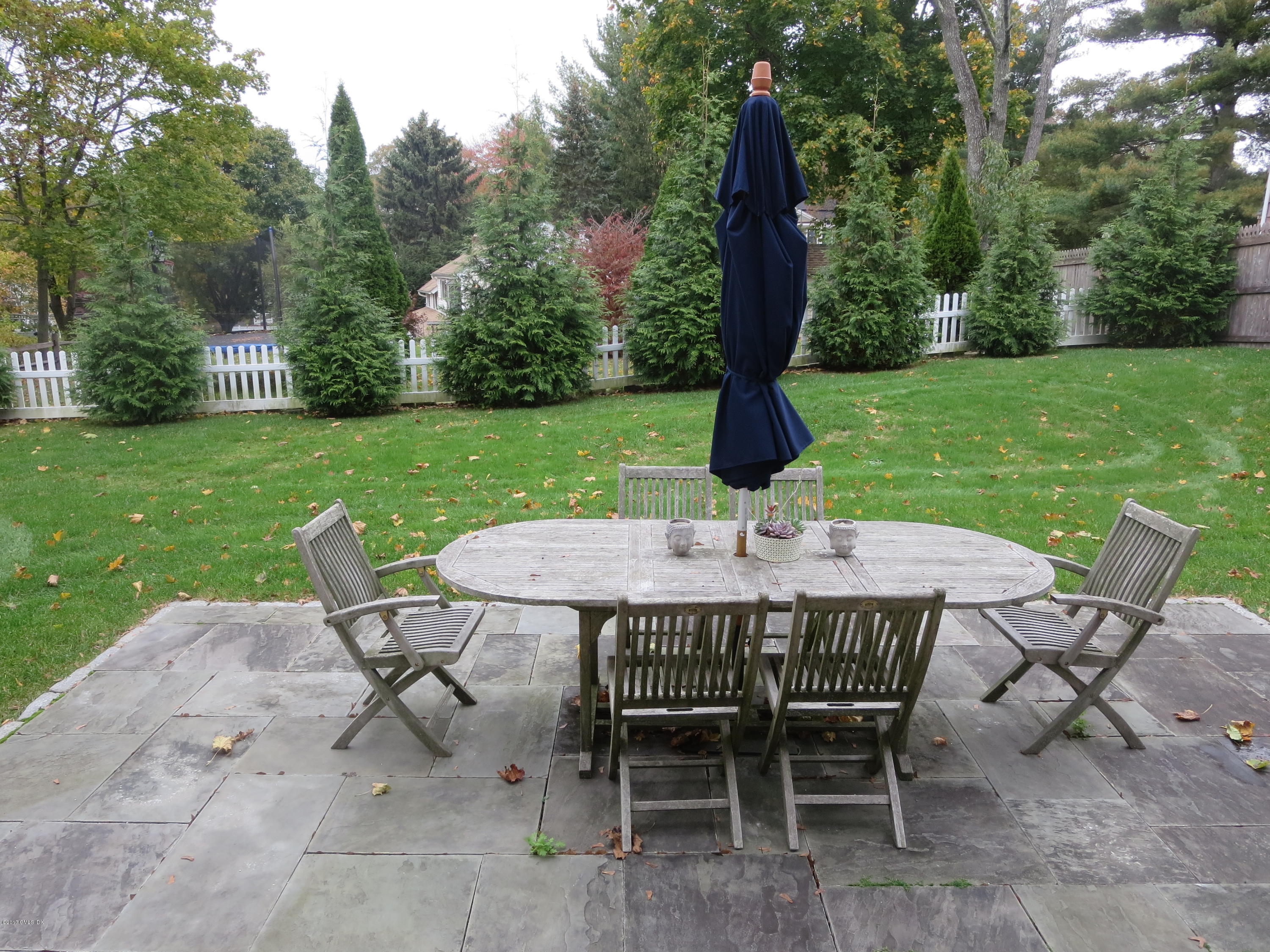 551 River Road Cos Cob, CT 06870 - Photo 34 of 40 a view of a backyard with a table and chairs