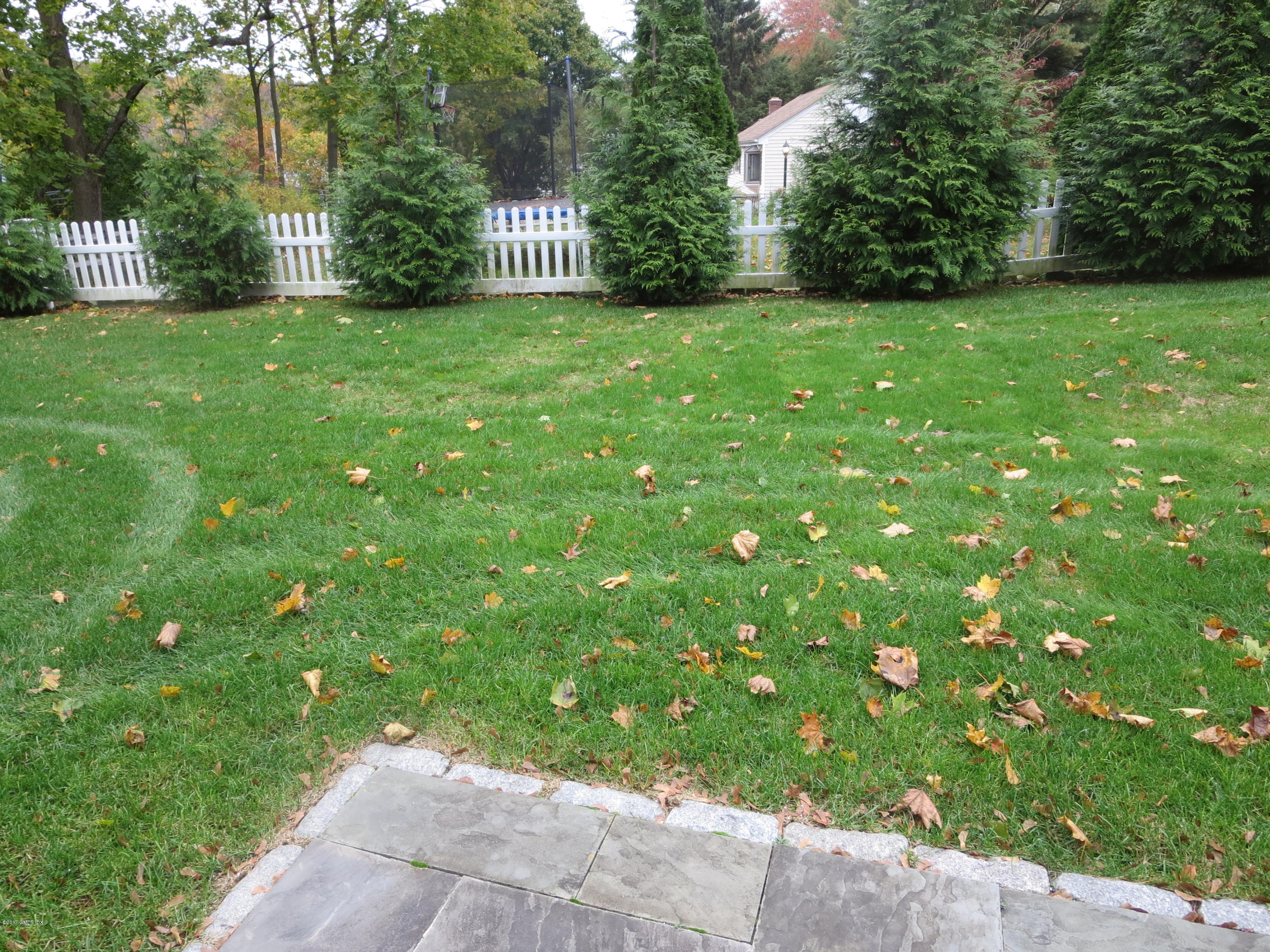 551 River Road Cos Cob, CT 06870 - Photo 36 of 40 a view of a street from a garden