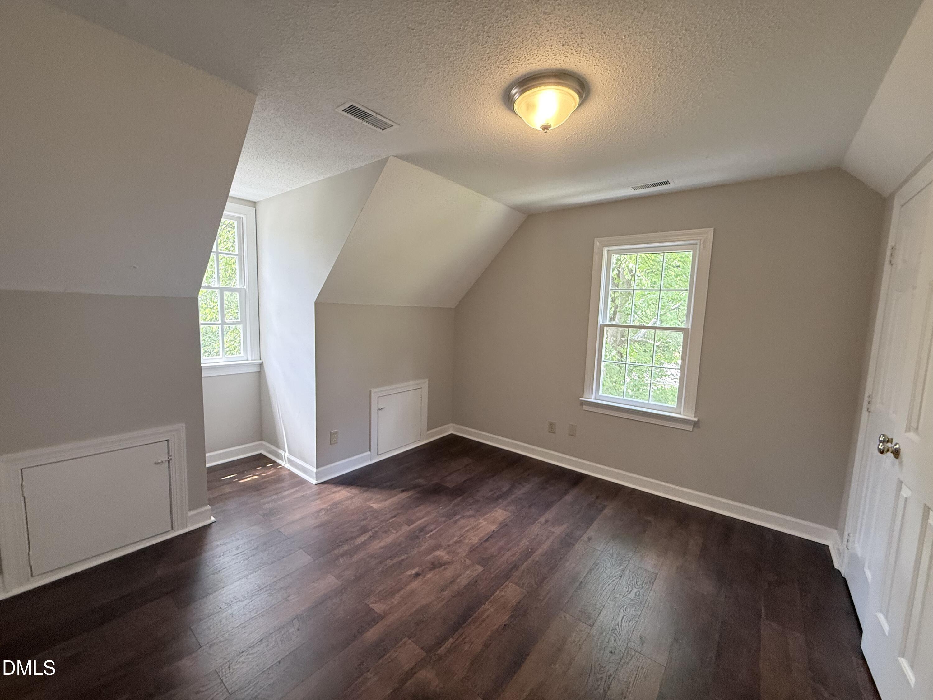 2900 Broadlands Drive Raleigh, NC 27604 - Photo 45 of 60 an empty room with wooden floor and windows