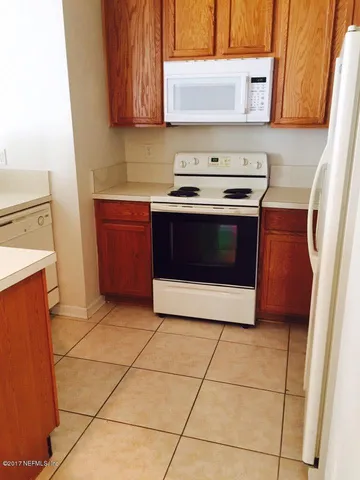 a kitchen with a stove top oven cabinets and a counter top space