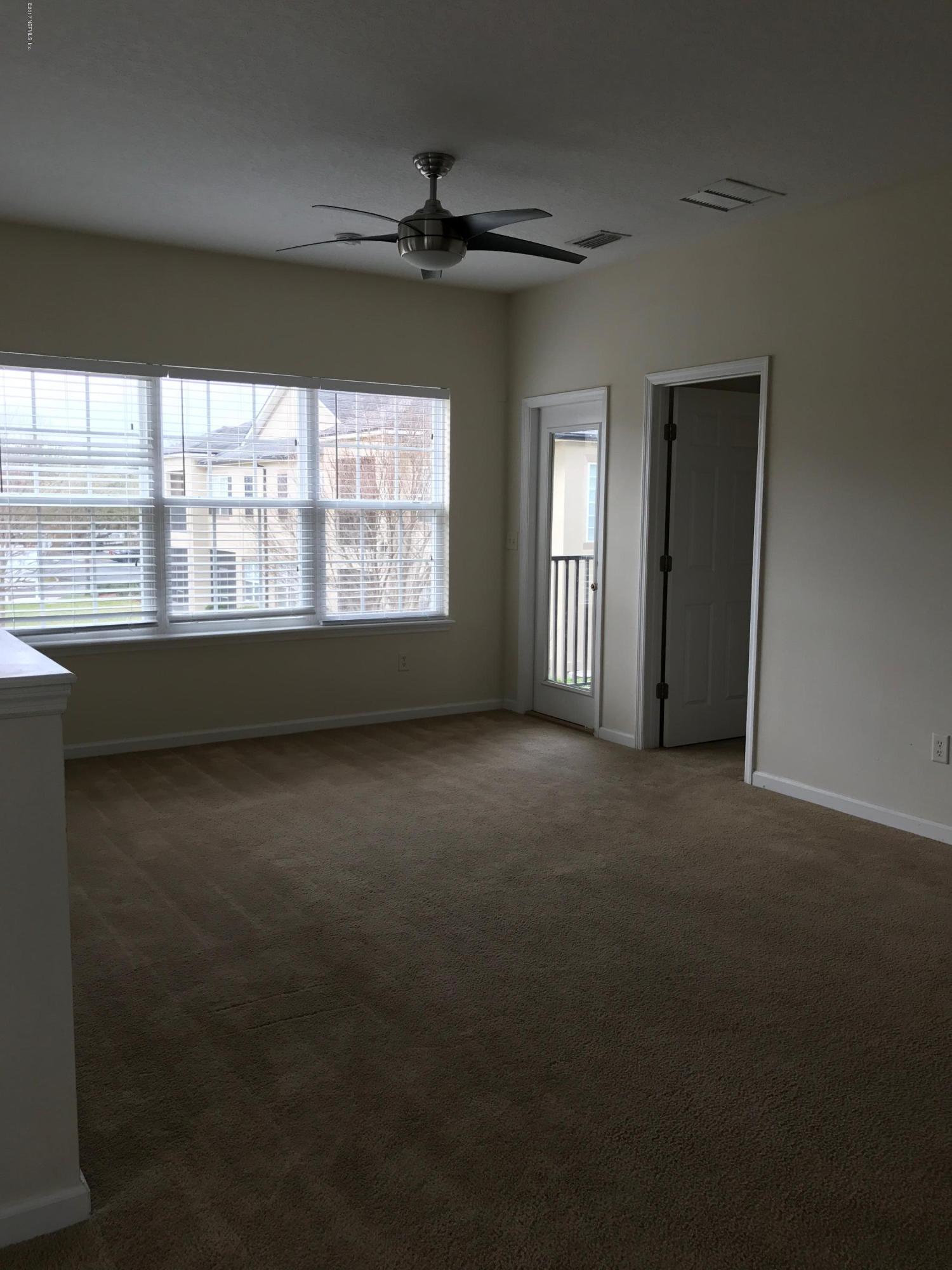 12301 Kernan Forest Boulevard, Unit 2202 Jacksonville, FL 32225 - Photo 24 of 38 a view of a livingroom with an empty space and a window