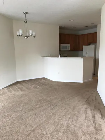 a view of a room with a furniture and floor to ceiling window