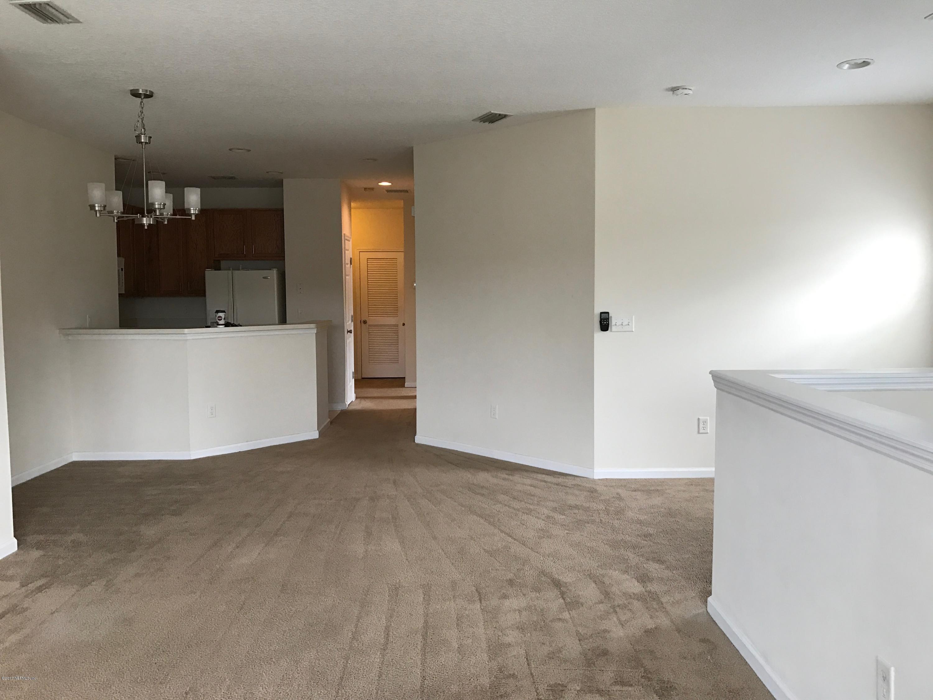 12301 Kernan Forest Boulevard, Unit 2202 Jacksonville, FL 32225 - Photo 30 of 38 a view of a room with a furniture and floor to ceiling window