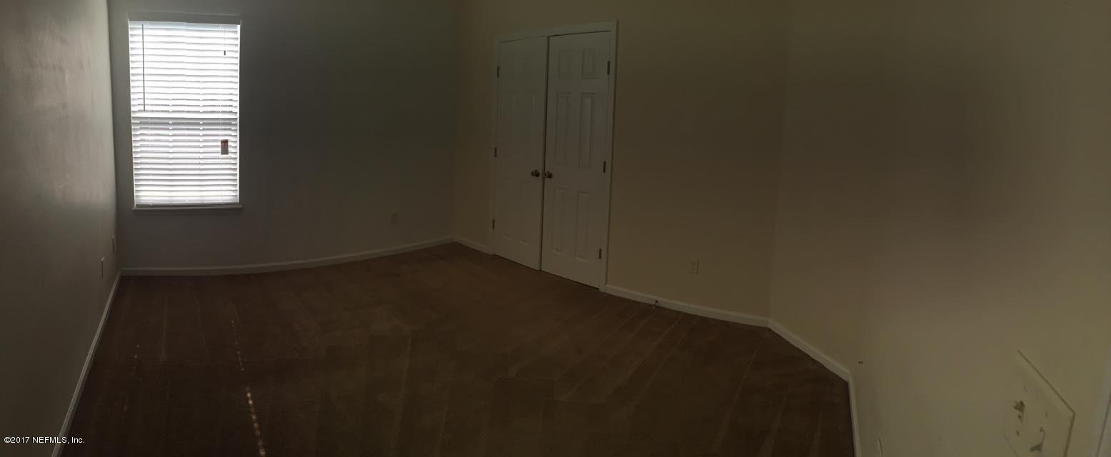 12301 Kernan Forest Boulevard, Unit 2202 Jacksonville, FL 32225 - Photo 5 of 38 a view of a small space with wooden floor and a window