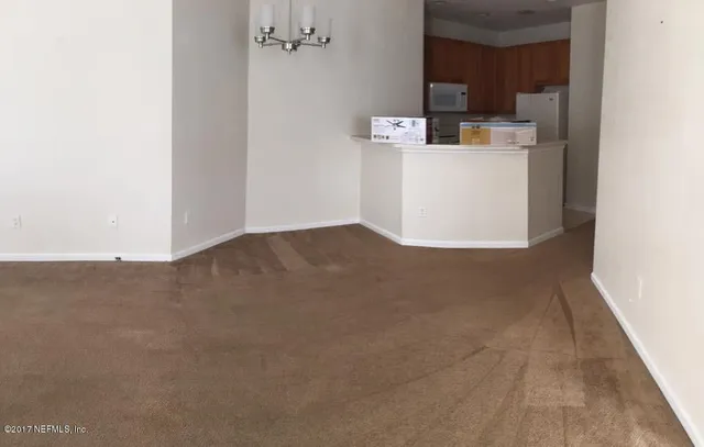 a view of kitchen cabinets and refrigerator
