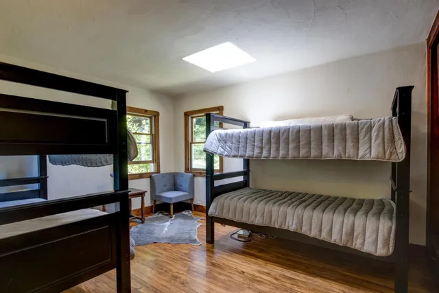 a bedroom with a bed chair and a window