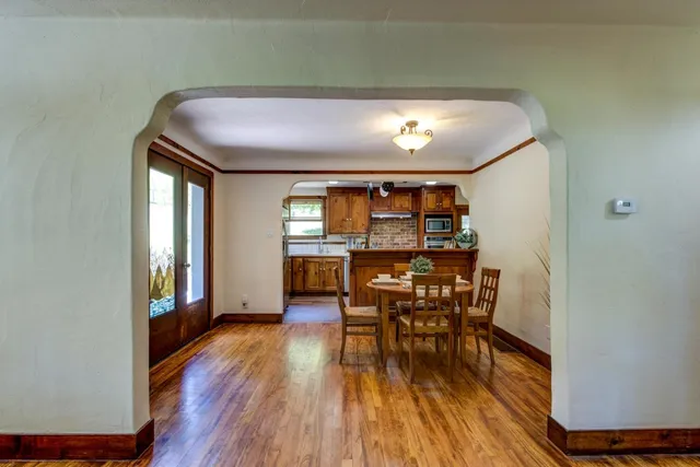 a view of a dining room with furniture and wooden floor