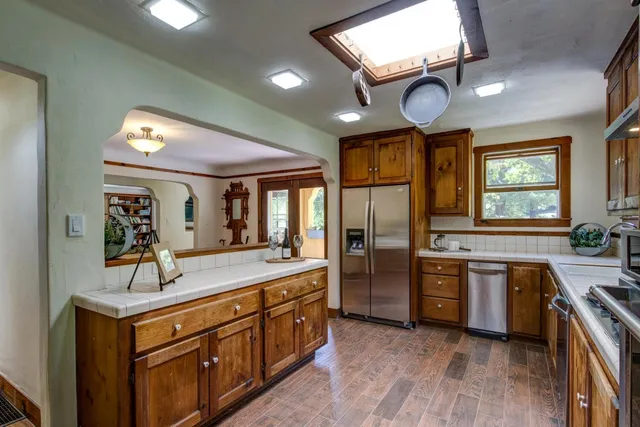 a spacious bathroom with a granite countertop sink and a large mirror