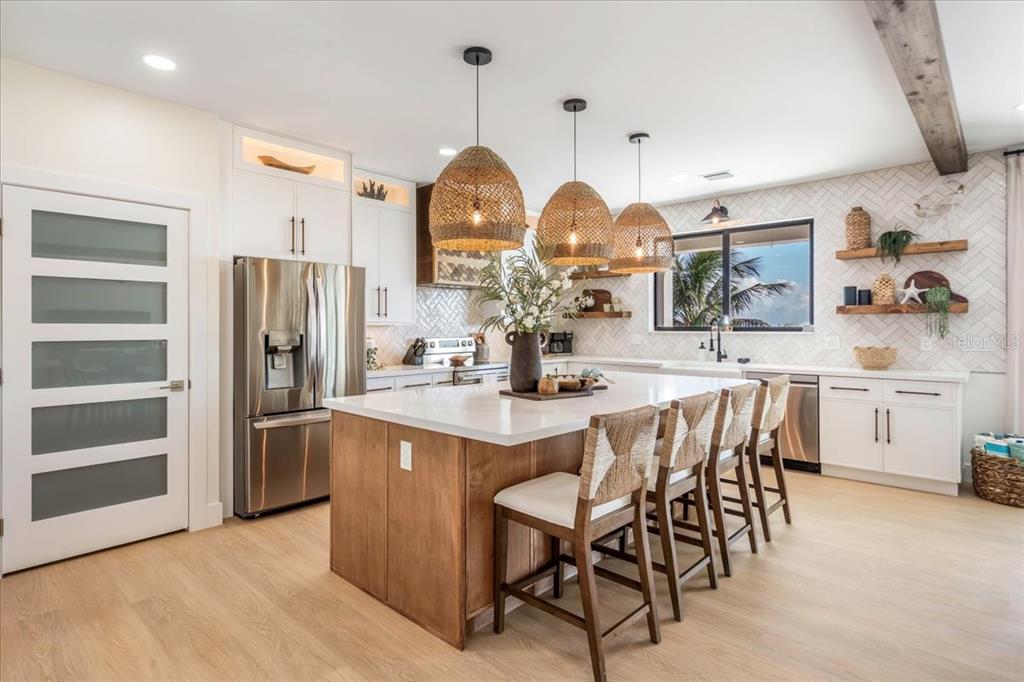 1000 68th Street Marathon, FL 33050 - Photo 25 of 75 a kitchen with stainless steel appliances granite countertop a sink a stove and a refrigerator