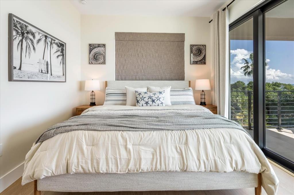 1000 68th Street Marathon, FL 33050 - Photo 45 of 75 a bedroom with a large bed and a painting on the wall