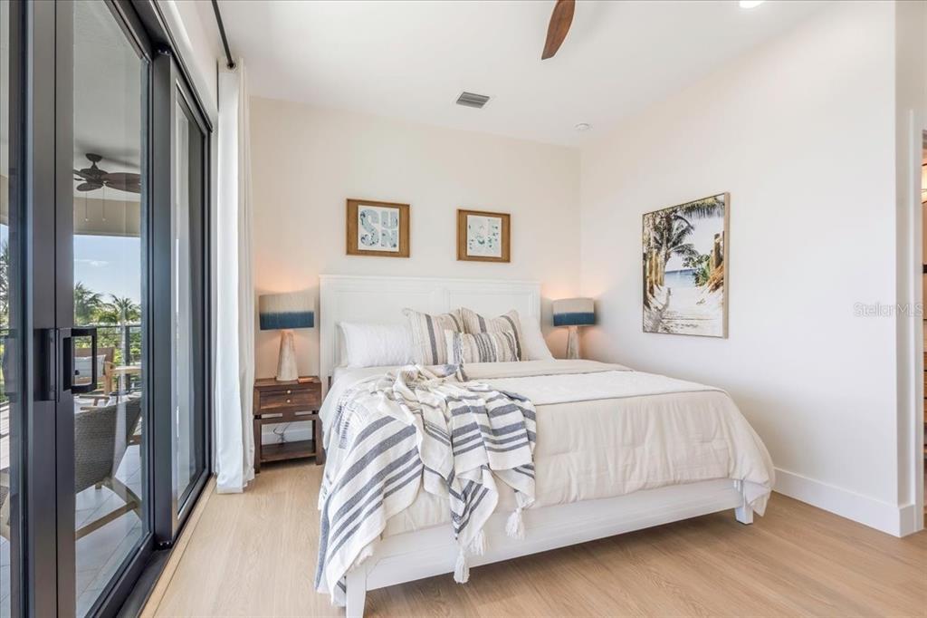 1000 68th Street Marathon, FL 33050 - Photo 50 of 75 a bedroom with a bed and glass wall