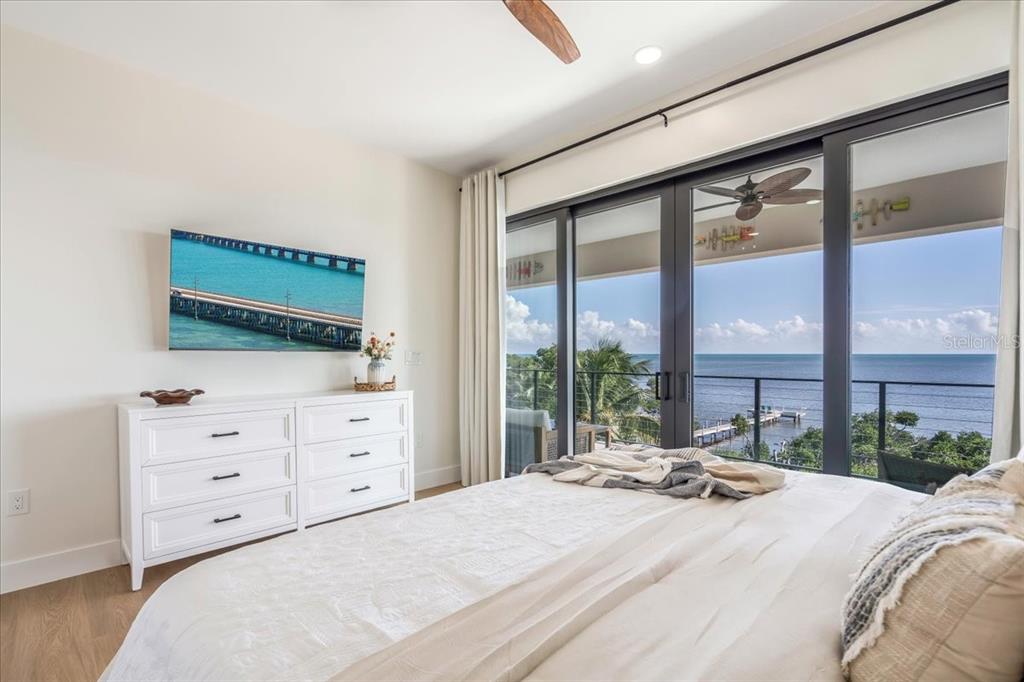 1000 68th Street Marathon, FL 33050 - Photo 51 of 75 a bedroom with a bed and a large window