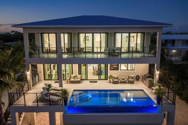 a swimming pool with outdoor seating and garden