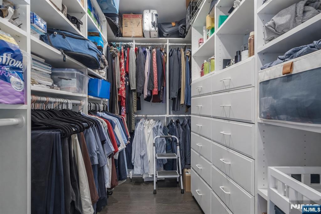 314 The Promenade Edgewater, NJ 07020 - Photo 19 of 37 a view of walk in closet with clothes and shoes