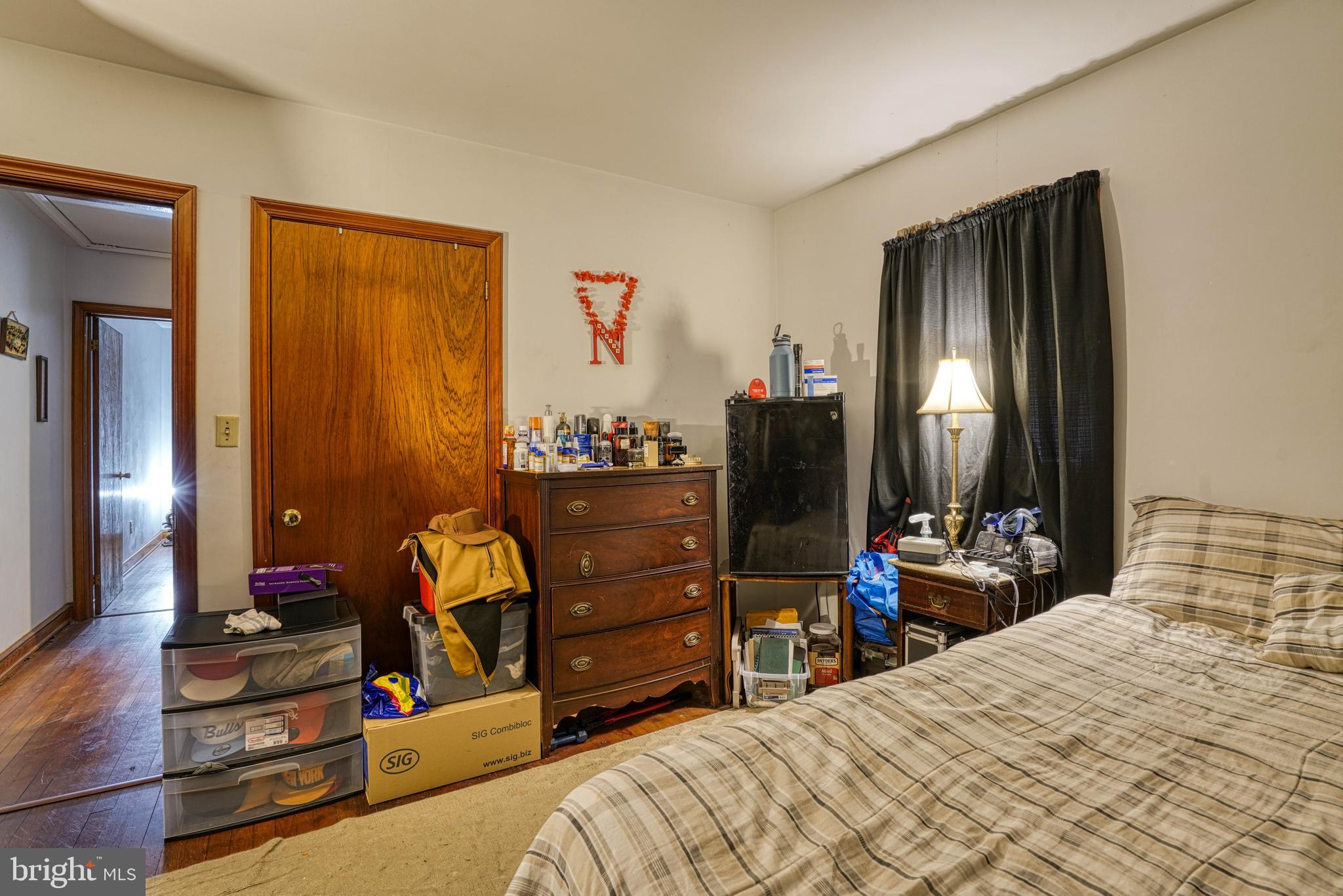 1200 Race Street Cambridge, MD 21613 - Photo 12 of 18 a bedroom with a bed and wooden floor