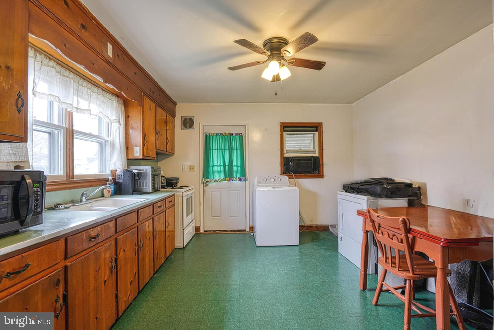 1200 Race Street Cambridge, MD 21613 - Photo 5 of 18 a large kitchen with a table and chairs