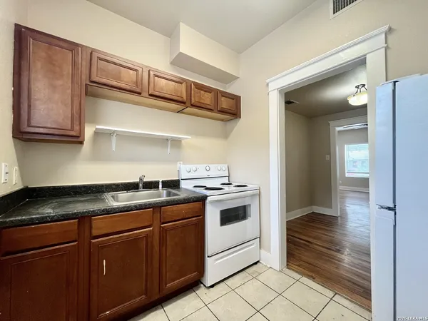a kitchen with stainless steel appliances granite countertop a stove and a sink