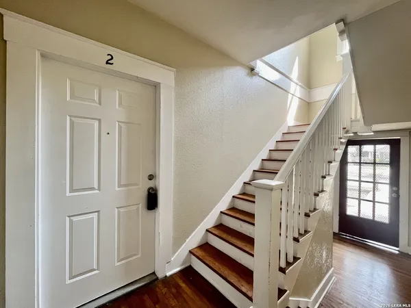 a view of entryway with wooden floor and stair