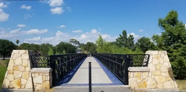 a view of balcony with wooden floor and fence