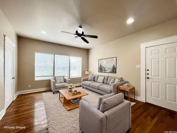 a living room with furniture and wooden floor