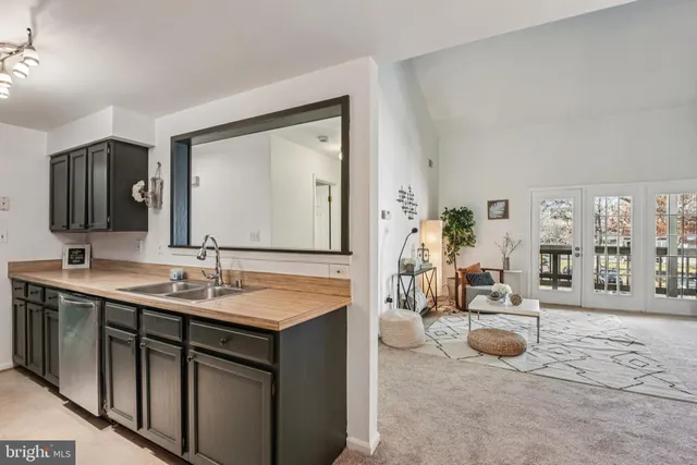 a kitchen with a refrigerator a stove and a sink