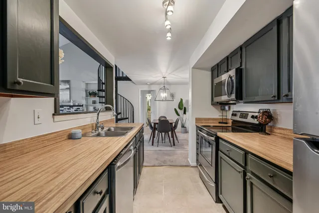 a kitchen with stainless steel appliances granite countertop a sink and a stove