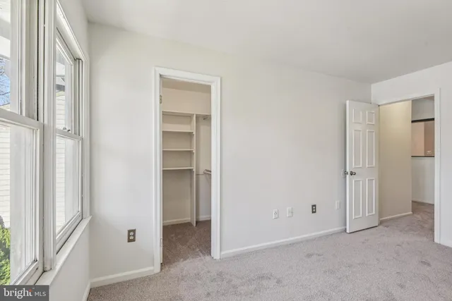a view of a storage and utility room with wooden floor