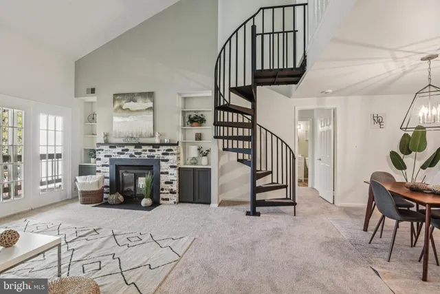 a view of hall way with furniture and a fireplace