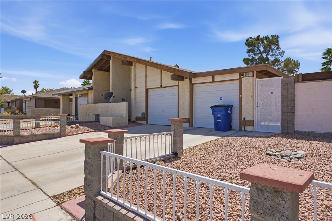 3971 Spring Leaf Drive Las Vegas, NV 89147 - Photo 47 of 48 A well-maintained facade features a practical double garage and gravel landscaping.