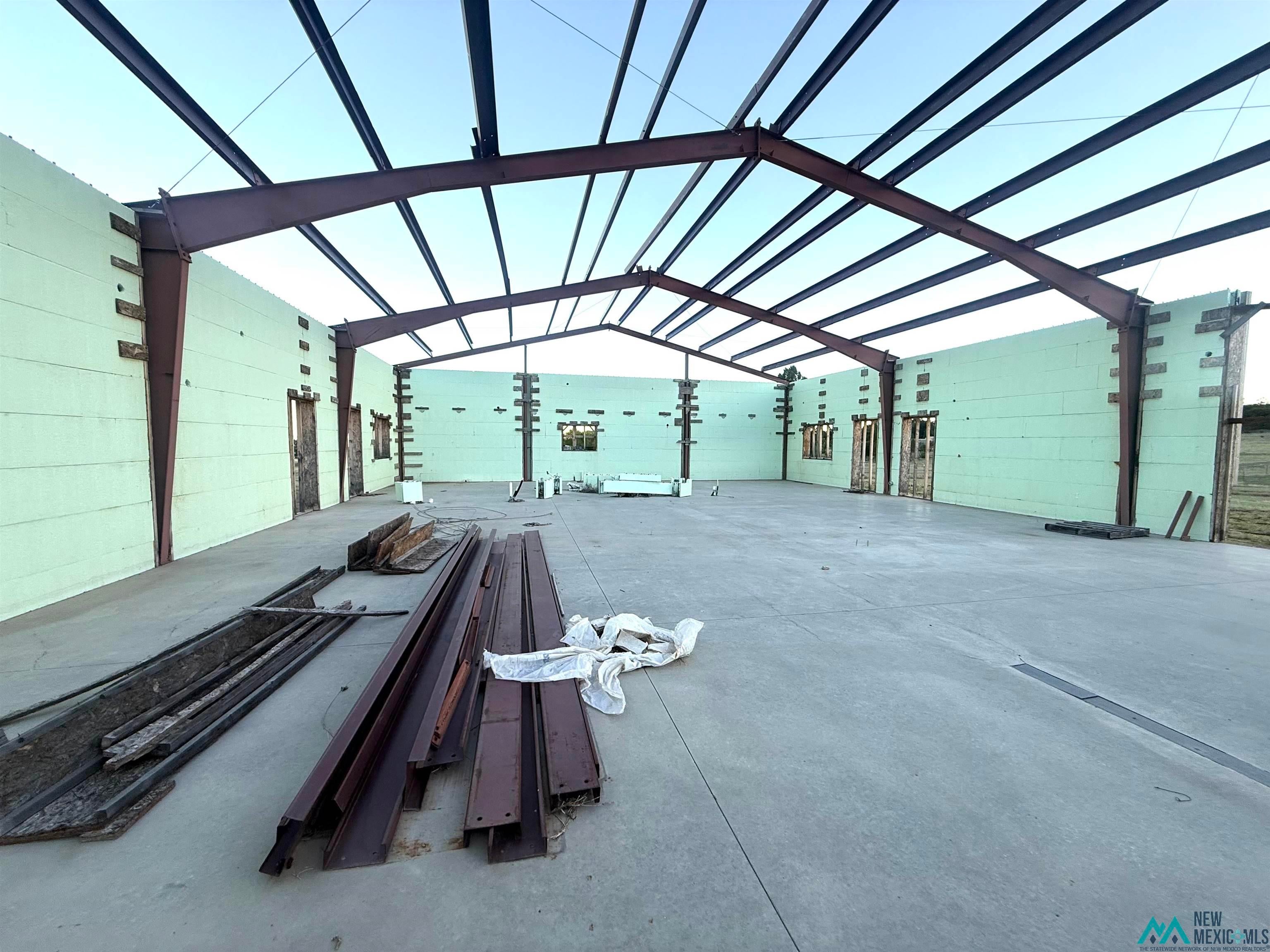 25 Linwood Road Raton, NM 87740 - Photo 32 of 41 Steel frame structure featuring a concrete slab floor, insulated concrete form (ICF) walls, and multiple window/door openings