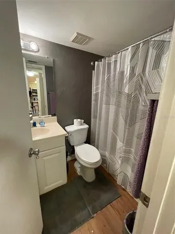 a white toilet sitting next to a bathroom sink