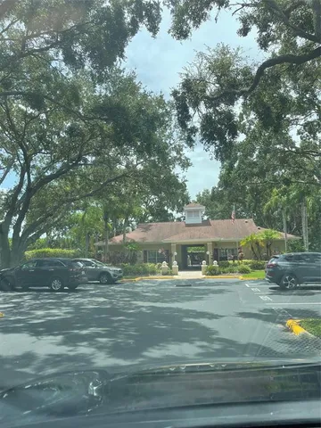 a view of pool with yard and trees in the background