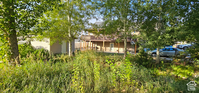 2269 Clear Creek Road Nibley, UT 84321 - Photo 21 of 27 Rear view of house with a deck, a patio, and an outbuilding