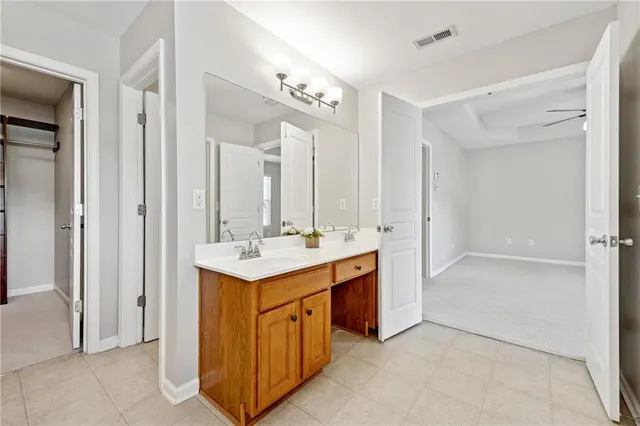 a bathroom with a sink double vanity and a mirror