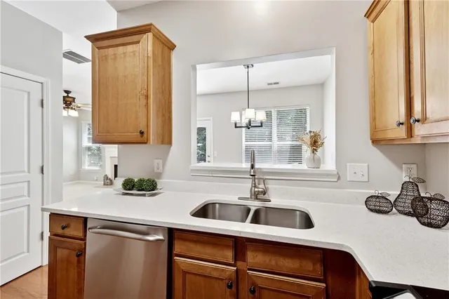 a kitchen with a sink cabinets and window