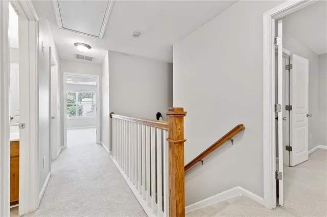 a view of a hallway with a door and stairs
