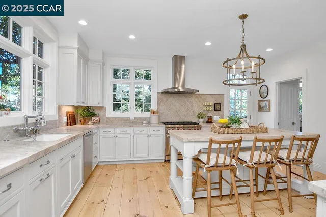 a kitchen with stainless steel appliances granite countertop a stove oven and a refrigerator