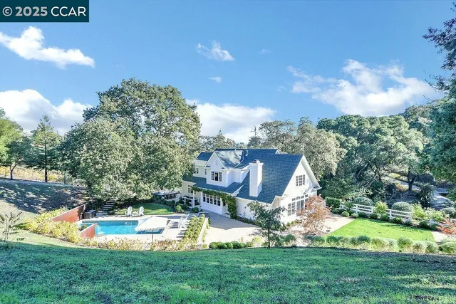 a living room with furniture a table and a large window
