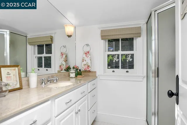a living room with furniture wooden floor and a large window