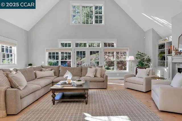 a dining room with furniture a chandelier and wooden floor