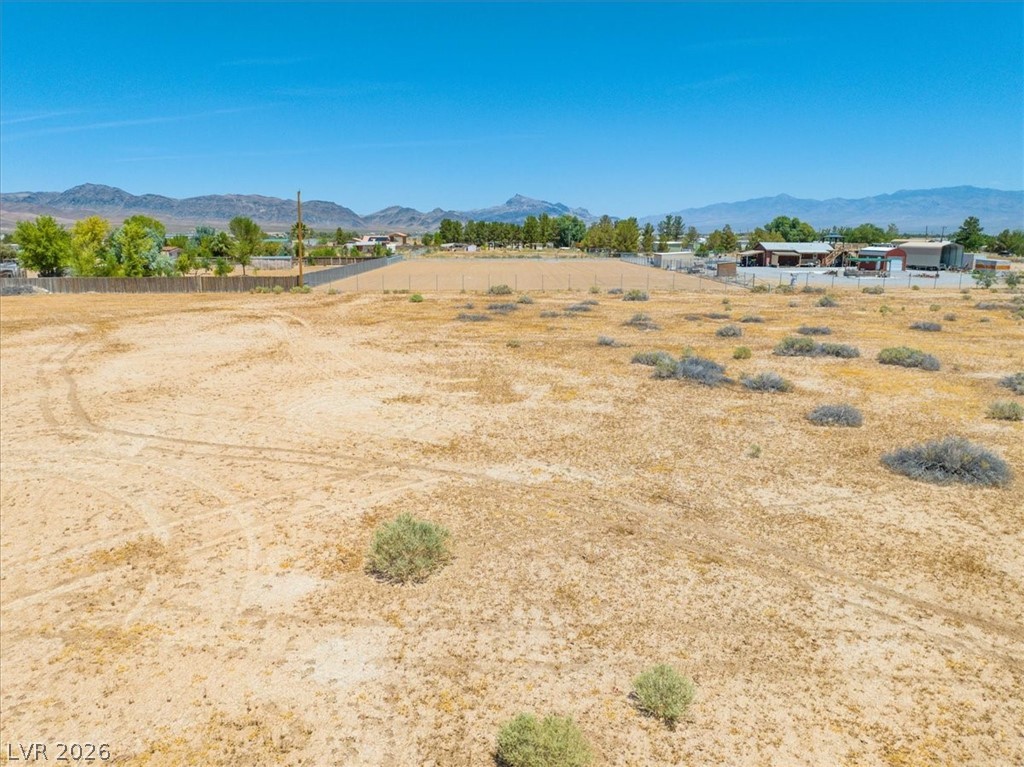 4610 Lawrence Road Pahrump, NV 89048 - Photo 6 of 42 A spacious desert lot offers expansive views of distant mountains and surrounding properties.