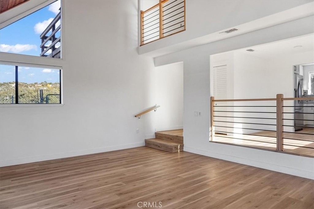 59470 Burnt Valley Road Anza, CA 92539 - Photo 11 of 18 a view of empty room with wooden floor and fan