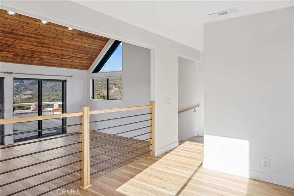 59470 Burnt Valley Road Anza, CA 92539 - Photo 12 of 18 a view of a hallway with wooden floor and windows