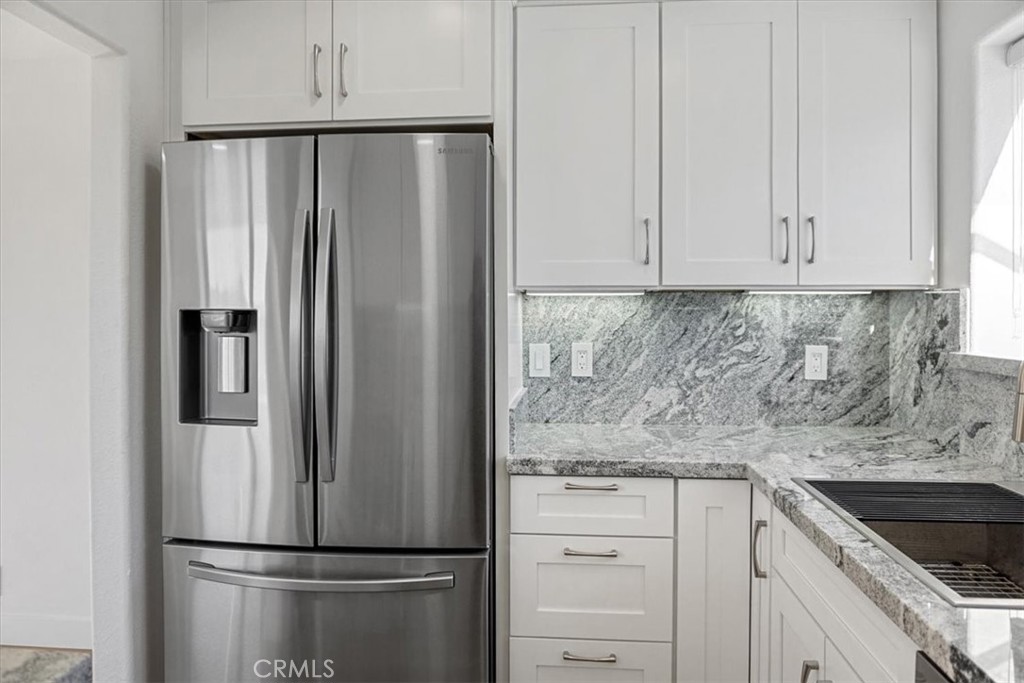 59470 Burnt Valley Road Anza, CA 92539 - Photo 5 of 18 a kitchen with metallic refrigerator freezer and cabinets